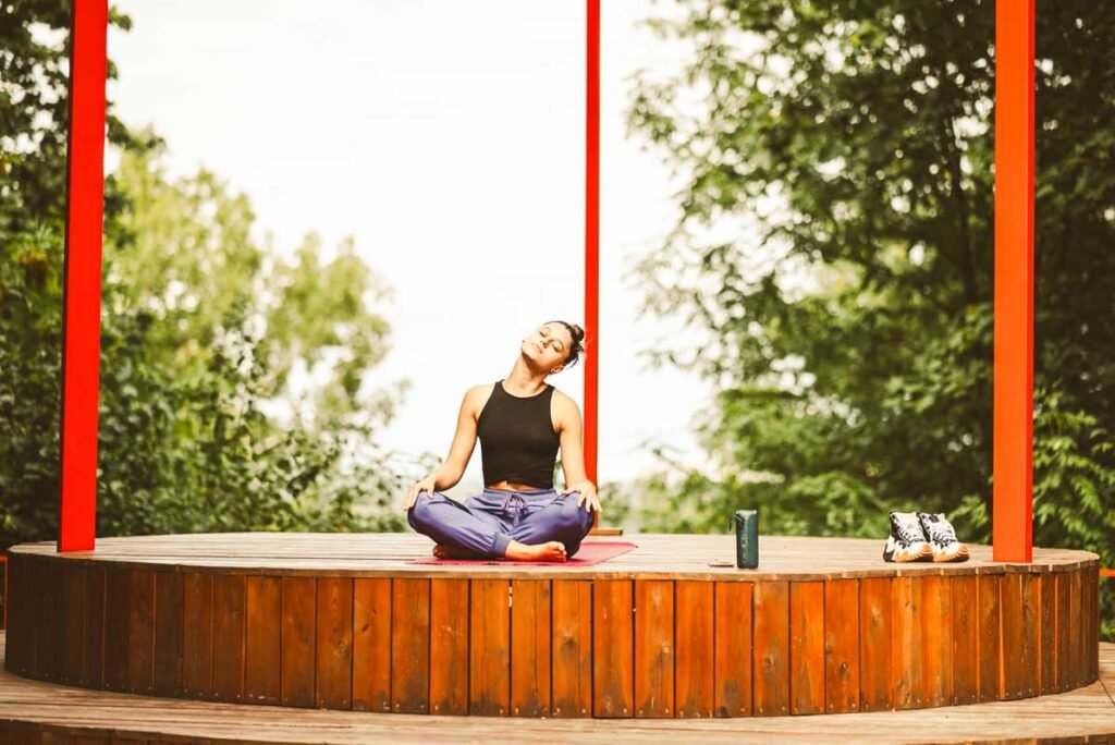 Junge Frau praktiziert Yoga im Lotussitz